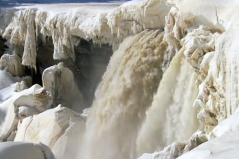 Water Gushes through frozen Falls